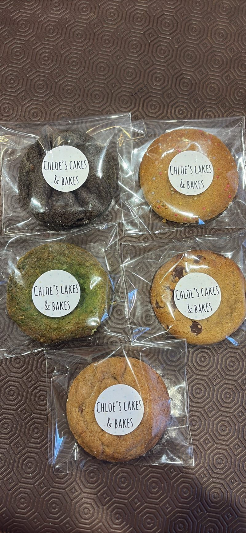 Assorted individually bagged cookies, each labelled with a Chloe's Cakes & Bakes sticker